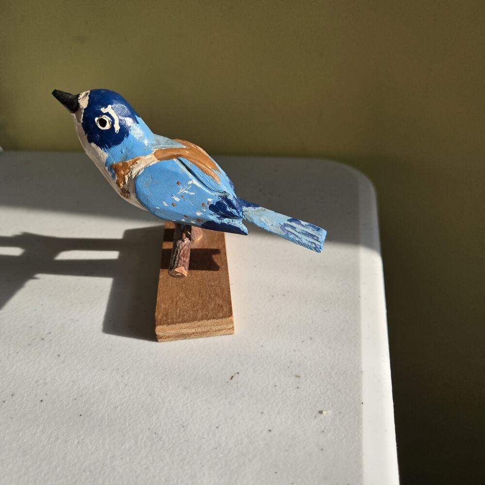Wood Carved Bird In Blue Sitting On The Log WF